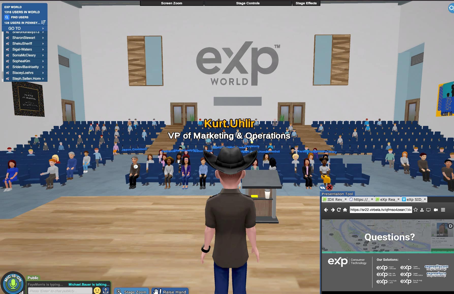corporate speaker Kurt Uhlir in metaverse event on Virbela. A virtual auditorium features a speaker at a podium engaging an online audience. 