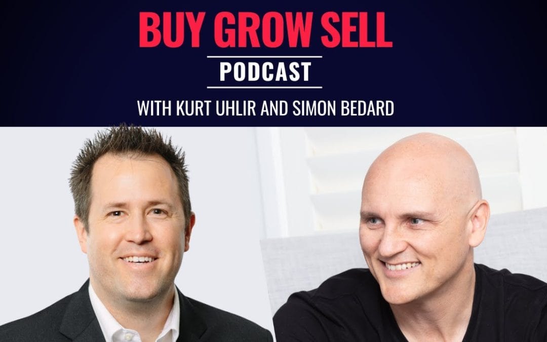 Two men smiling—Kurt Uhlir in a suit and another in a casual shirt. Text above reads: "Buy Grow Sell Podcast with Kurt Uhlir and Simon Bedard." Learn about Buy vs. Build strategies and Earn-Outs on a dark background.